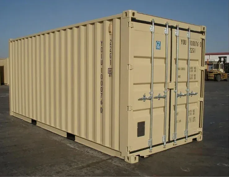 A new tan 20-foot shipping container with its doors closed, standing on a paved lot
